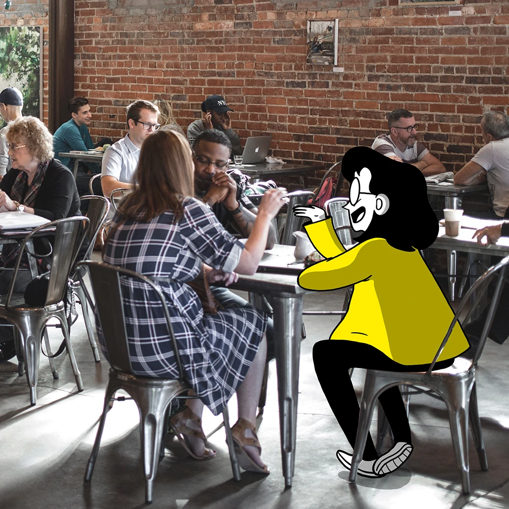 nwb nautilus illustrierte Figur sitzt in realer Umgebung am Tisch im Gespräch